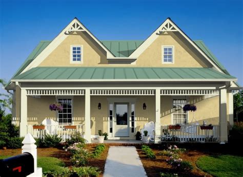 brick house with green metal roof and yellow door|green roof exterior yellow.